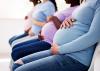 A group of pregnant women sitting on chairs